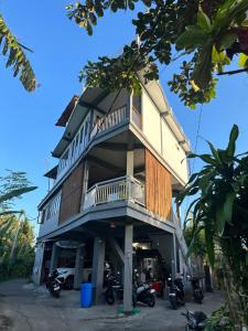 a tall building with motorcycles parked in front of it at Medewi Secret SurfCamp in Pulukan