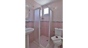 a bathroom with a shower and a toilet and a sink at Kiraz Butik Hotel in Alaçatı +45 photos