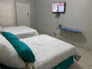 a hospital room with two beds and a tv at MOMENTS OF JOY GUESTHOUSE in Boksburg