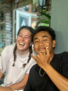 a man and a woman sitting next to each other at Medewi Secret SurfCamp in Pulukan