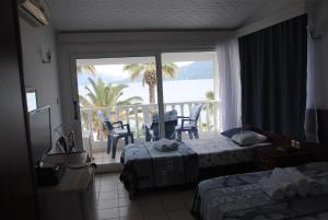 a hotel room with two beds and a balcony at Uysal Motel Beach in Marmaris