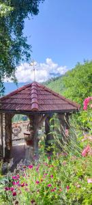a gazebo with a red roof in a field of flowers at Märchenschlössel Altenstein in Trebesing