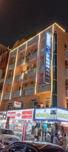 a tall building with signs in front of it at Tehran Hotel in Dubai