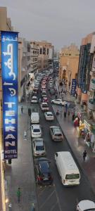 a busy city street with cars parked on the street at Tehran Hotel in Dubai
