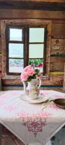 a vase of flowers on a table with a table cloth at Märchenschlössel Altenstein in Trebesing +64 photos