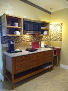 a kitchen with a counter with a sink and a sink at Hale Laule'a at Opihi Point - Oceanfront, Gated Estate in Hakalau