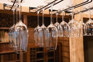 a bunch of wine glasses hanging from a rack at new! 熱海桃山邸　Atami terrace villa 〜Sauna & Onsen 〜 in Atami