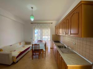 a kitchen with a couch and a bed in a room at Alti Holiday Apartments ONE in Orikum