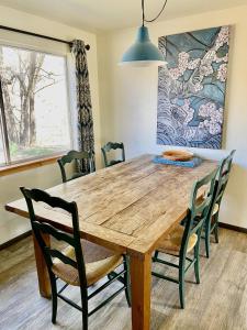 a dining room with a wooden table and chairs at The Finca - Moab's Hidden Gem in Moab