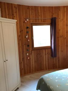 a bedroom with a window and a bed in a room at Chalet dans plusieurs hectares de nature in Barjols