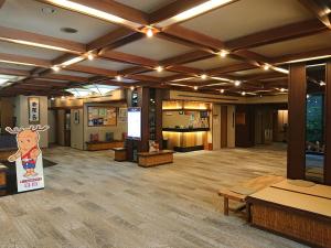 a large room with wooden floors and ceilings with lights at Kasuga Hotel in Nara