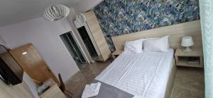Postel nebo postele na pokoji v ubytování OITUZ Boutique Residence