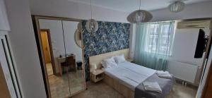 Postel nebo postele na pokoji v ubytování OITUZ Boutique Residence