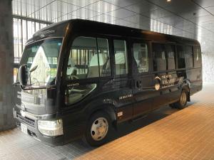 a black bus is parked in a building at THE HOTEL HIGASHIYAMA by Kyoto Tokyu Hotel in Kyoto