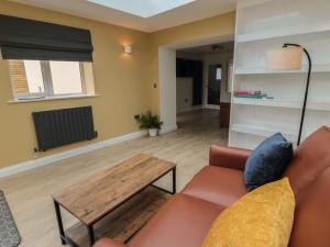 a living room with a couch and a table at 2 Staveley Cottages in Weaverthorpe