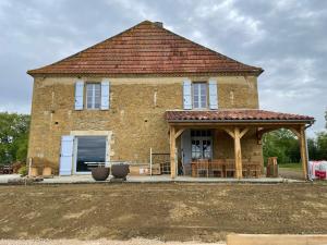 a brick house with a gazebo in front of it at Maison Cabet in Castelnavet