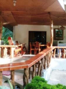 a porch with wooden chairs and a table at Villagracia HomeStay 