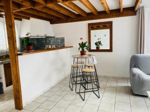 a kitchen with a counter and stools in a room at Ti kaz palmiers in Saint-Pierre