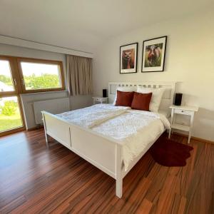 a bedroom with a white bed and two windows at Gut Schlafen - Am Kogl in Hypolz