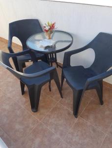 two chairs and a glass table with a table and two chairs at Alina in Năvodari