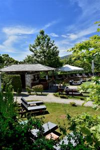 a group of tables and benches in a yard at Hotel Pelion Resort in Portaria