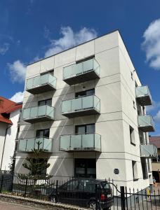 a white building with balconies on the side of it at Aruka in Władysławowo