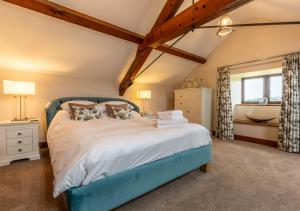 a bedroom with a blue bed in a room at Camlad Barn in Chirbury