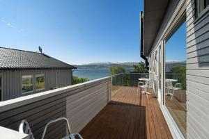 a balcony with a view of the water at Seaview studio w/terrace&parking in Tromsø