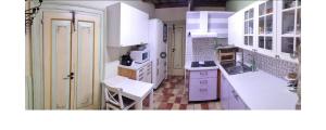a small kitchen with white cabinets and a sink at Joka in Potenza Picena