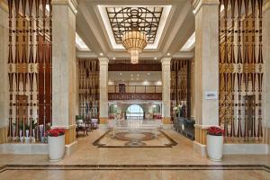 a lobby with a large building with a chandelier at Danang Marriott Resort & Spa in Da Nang