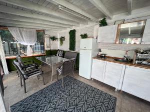 a kitchen with a table and a white refrigerator at House Varna-2 in Krapets