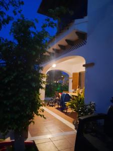 a view of a patio at night with a table at Chalet adosado con piscina in Vera