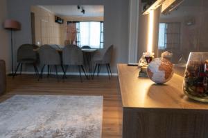 a living room with a table with a vase on it at Cosy 2 rooms apartment in the center of the city in Bucharest