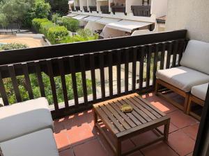 a balcony with a bench and a table and chairs at Appartement plein centre cap ferret in Lège-Cap-Ferret