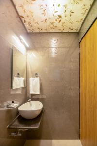 a bathroom with a white sink and a shower at The Majestic Boutique Hotel in Mumbai