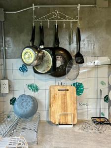a kitchen with pots and pans hanging from a wall at Blessing Moon Pool Villa Khaoyai in Ban Tha Wua Tai