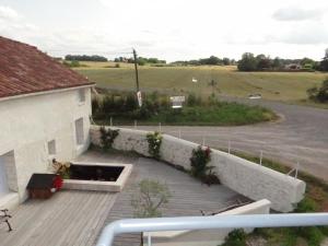 a balcony of a building with a flower garden at L'Oratori : chambre La Gabarre in Sérignac