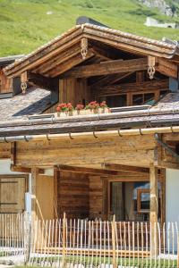 a wooden house with flowers on the roof at Fürthermoar Hideaways in Kaprun