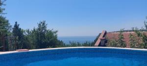 a swimming pool with a view of the ocean at sea view hygge - Quiet residential apartment in Kavarna +25 photos