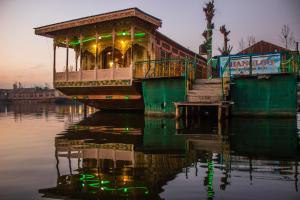a boat on the water with its lights on at Houseboat New Manora in Srinagar