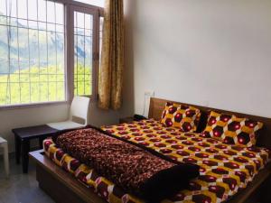 a bedroom with a large bed and a window at The Bagain in Shimla