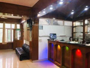 a kitchen with a bar and a couch in a room at The Bagain in Shimla