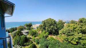 a view of the beach from the balcony of a house at Nushev Hotel in Sveti Vlas