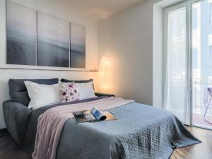 a bedroom with a bed with a book on it at La Malva - L'Opera Group in La Spezia