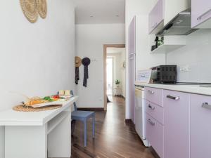 a kitchen with white cabinets and a counter top at La Malva - L'Opera Group in La Spezia +19 photos