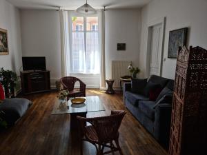 a living room with a couch and a table at Les Gites du 74 R Le Classique in Senones +41 photos