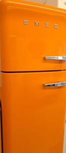 an orange refrigerator freezer sitting in a kitchen at Casa bragosso in Sottomarina