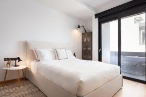 a white bedroom with a large bed and a window at Luxury Apartment, Athens Center, "ORION" in Athens