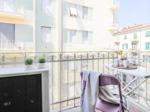 a balcony with a table and a chair at La Malva - L'Opera Group in La Spezia