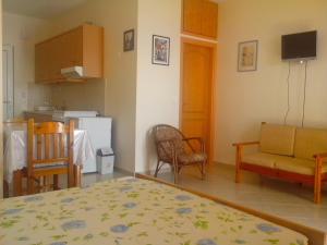 a room with a kitchen and a living room at Seaview Studio in beautiful setting west from Chania in Ravdhoúkha